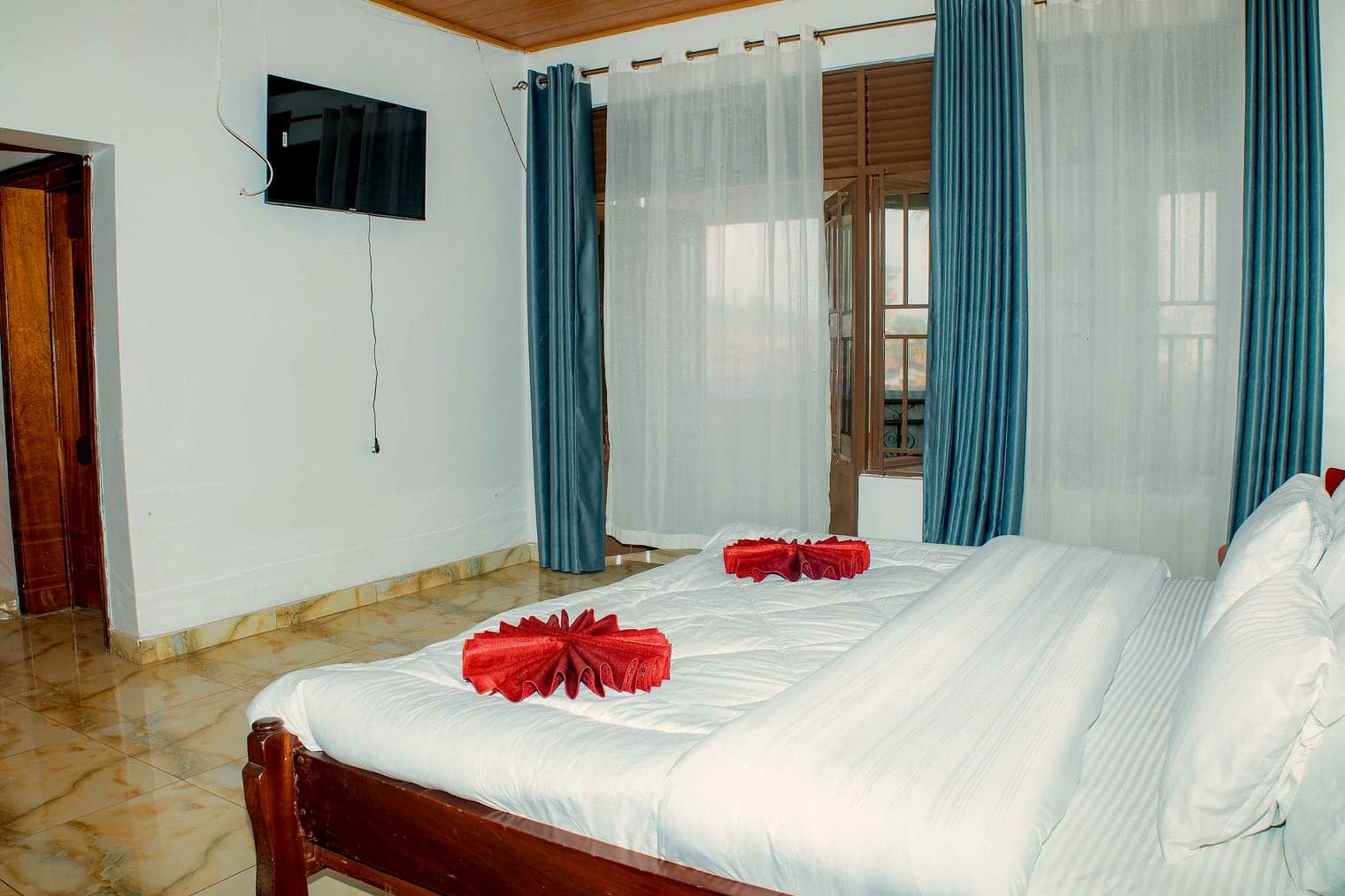 Pillows and folded towels at the foot of the Kigali room bed